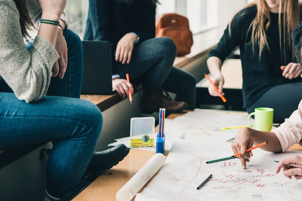 A team discussing work around a table, representing collaboration between product, engineering, and customers.
