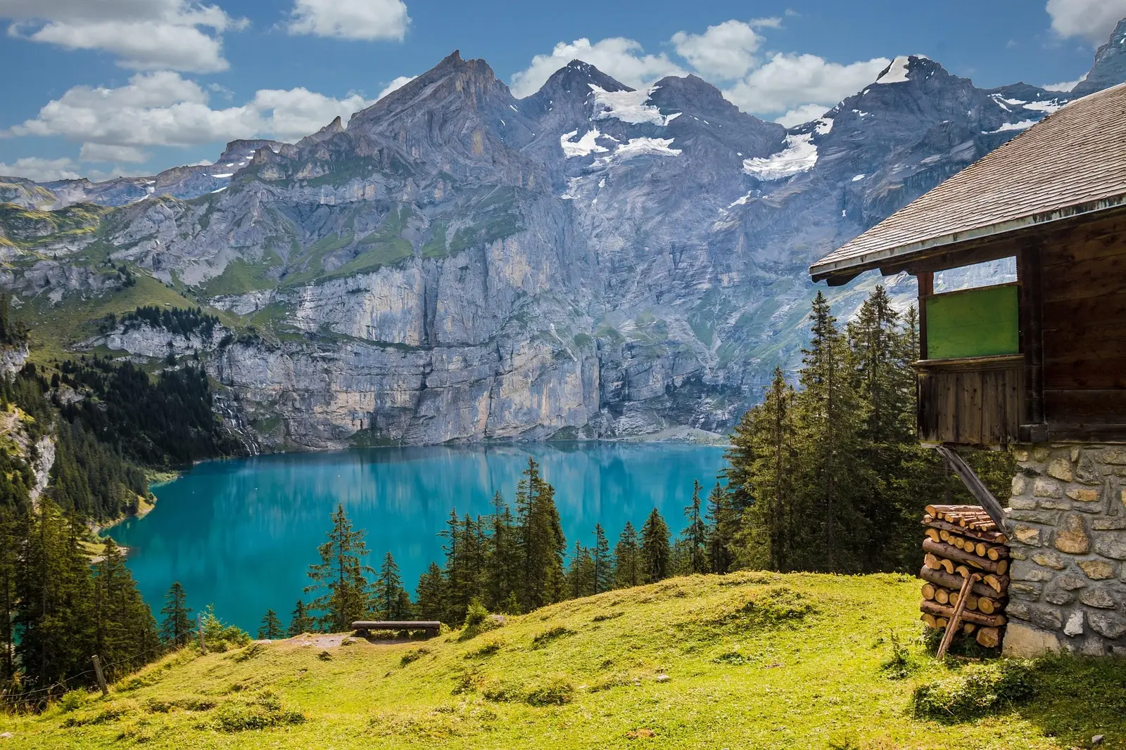 An alpine cabin beside a lake representing sustainability and long-term responsible operations.